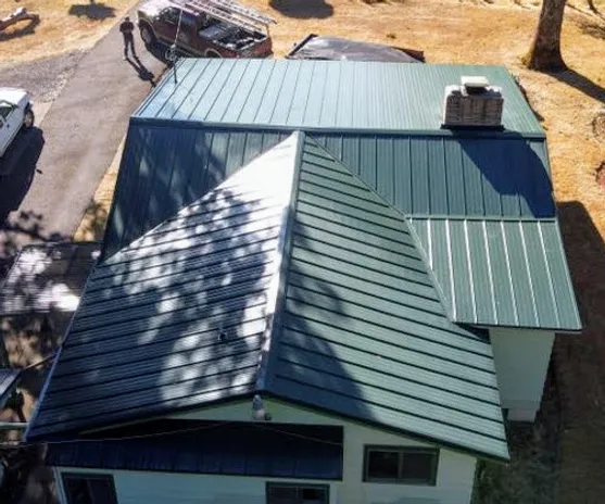 Drone shot of new green metal roof installation project in Hillsboro, OR