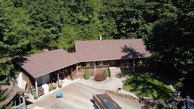 Drone shot of roof replacement and skylight installation project in Chapman, OR