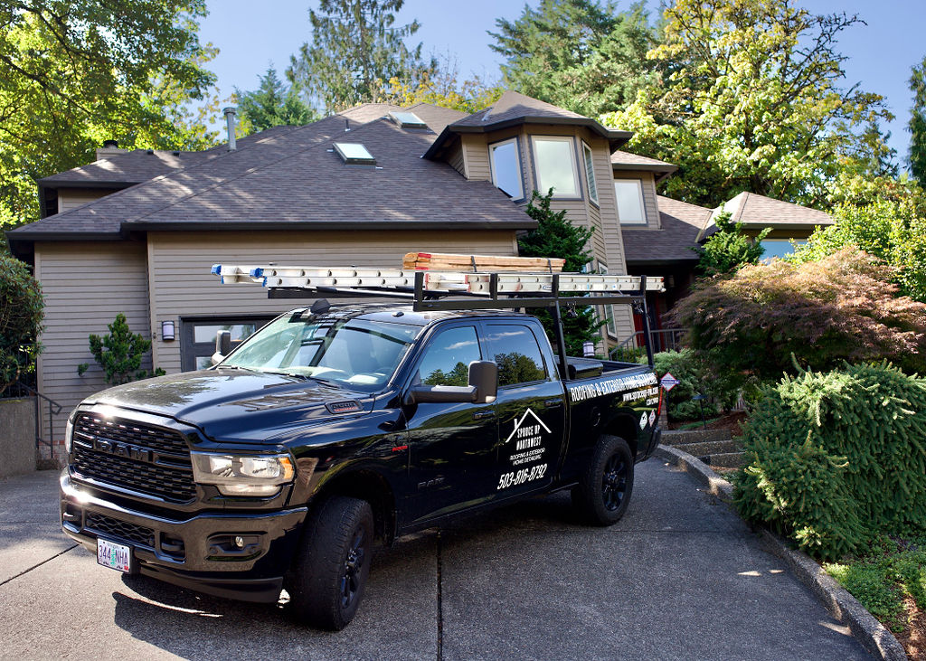 Two-story home with Spruce Up Northwest work truck parked in driveway